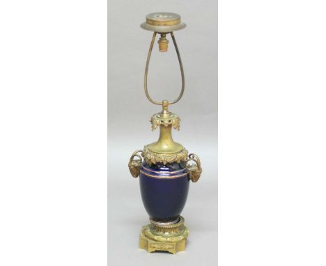 FRENCH PORCELAIN AND BRASS MOUNTED TABLE LAMP, in mazarin blue with gilt banding, goat head handles and fruiting vine rim, he