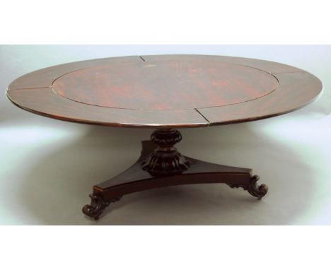 REGENCY ROSEWOOD EXTENDING DINING TABLE, the circular tilt top, with four additional rosewood effect leaves, on a baluster tu