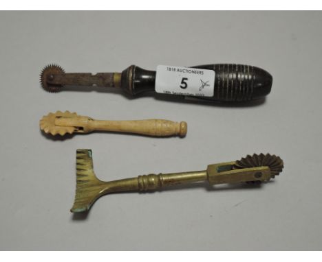 Two vintage pie or pasty crimping wheels, one brass and the other wood also included is a copy wheel.