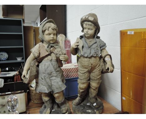 Two late Victorian terracotta figures of Dutch boy and girl fishing having had repairs 87cm tall in the manner of Goldscheide