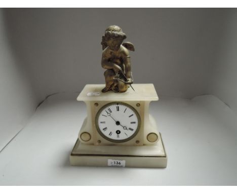 An early 20th century alabaster mantel clock having gilt cherub to top, enamel face and Roman numerals, devoid of back plate.