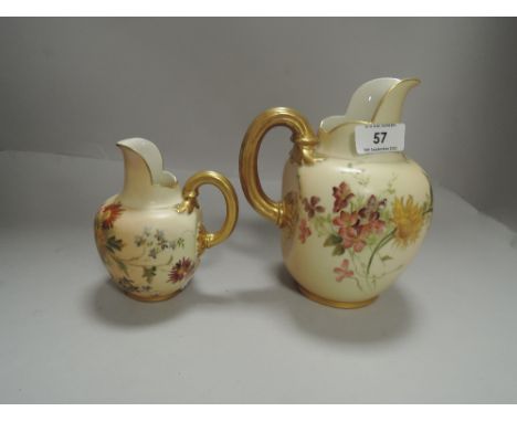 Two Royal Worcester blush ivory jugs having gilt handles with hand painted floral scenes larger dated 1906