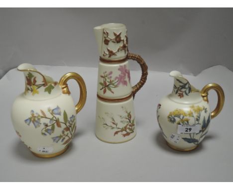 Three pieces of fine Royal Worcester blush ivory including two gilt handle jugs hand painted with floral and gilt designs and