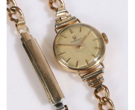 Omega 9 carat gold ladies wristwatch, the signed champagne dial with baton markers, manual wound, the case 19mm diameter, on 