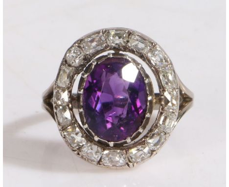 18 carat gold, amethyst and diamond set ring, with a central amethyst and a diamond surround, ring size L, 5.2g