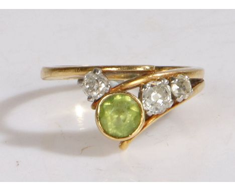 An 18 carat gold, peridot and diamond ring by Tom Payne, ring size R, 6.4 grams