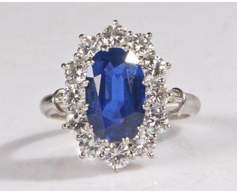 An Impressive 18 carat gold sapphire &amp; diamond cluster ring, the head set with a cushion cut Shi Lanka Ceylon natural sap