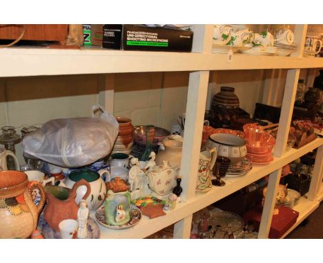 Full shelf of glass and china, figures, Charlotte Rhead style jug, wood pieces, etc