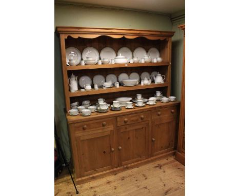 Large pine dresser having shelf back above three drawers with three cupboard doors below