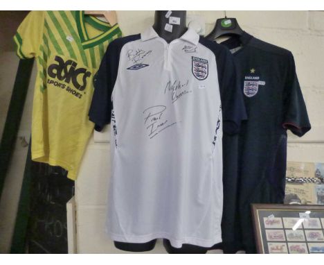 An England football shirt bearing signatures Paul Ince, Michael Owen and others together with a further England shirt and a v