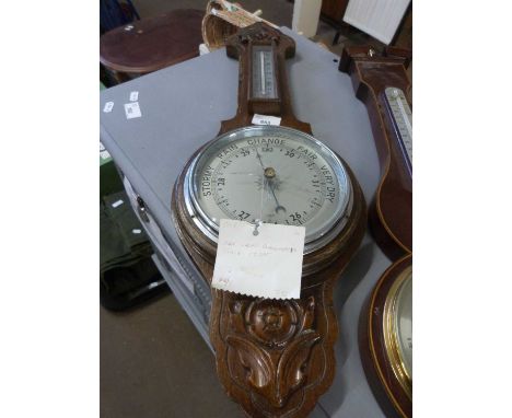A reproduction mahogany barometer with chrome face