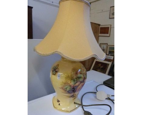 An Aynsley table lamp with golden yellow coloured shade