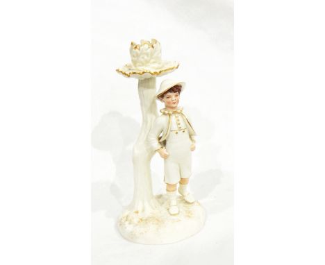 A Victorian Royal Worcester figural candlestick modelled as a tree with oak leaf sconce, a boy standing in front of it, with 