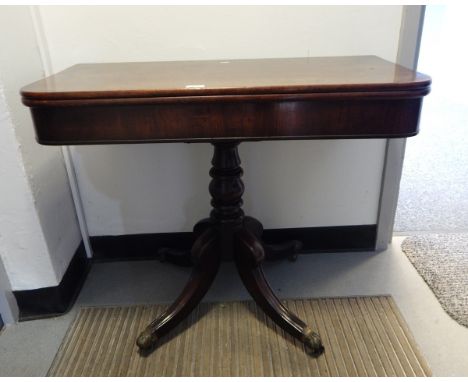 A Victorian mahogany fold-over card table on bulbous turned columns, cabriole legs with paw castors, 92cm wide 