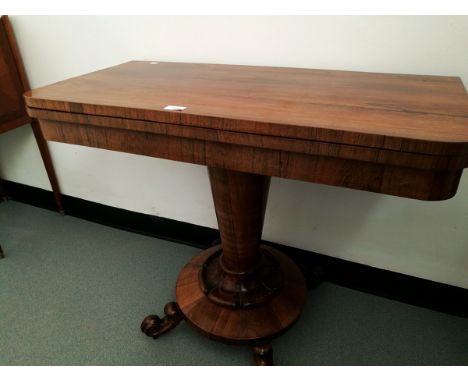 A mahogany rotating top card table with circular base inset, on circular tapering column, on scroll and castor feet, 92cm wid
