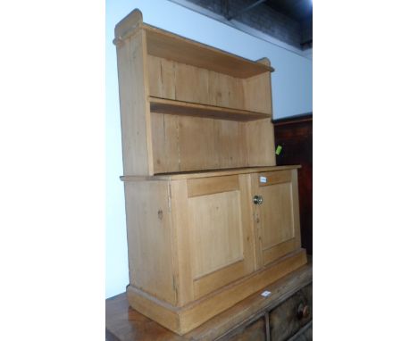 A pine dwarf display cabinet with open shelf, cupboard to base, on block plinth, 80cm wide 