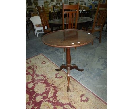 A Georgian mahogany tilt-top tripod table with baluster stem