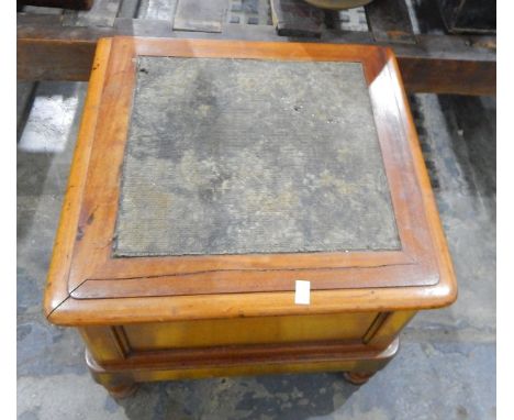 A mahogany commode of square form with hinged upholstered lid, on bun feet 