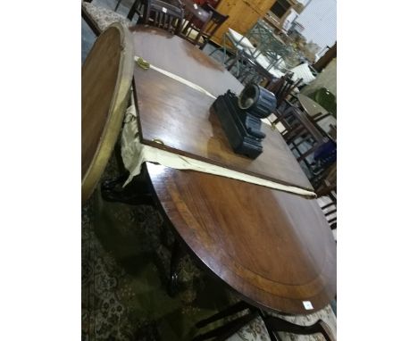 A mahogany D-end extending dining table with walnut and ebonised inserts, on two tripod stands together with leaf, 180cm long