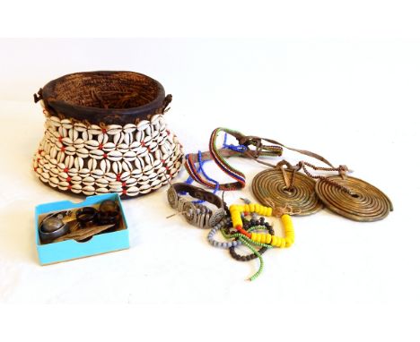 Two African brass coils, beadwork jewellery items, tortoiseshell rings, uncut boulder opals and African shell-mounted leather