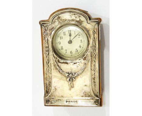 A silver mounted mantel clock, Birmingham 1912 with arched pediment and decorated with garlands of ribbons and flowers 