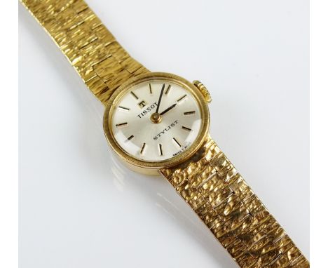 A lady's 9ct gold Tissot stylist bracelet wristwatch, the circular silvered dial with batons, manual wind, with integral bark