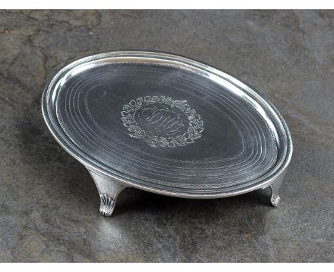 A George III silver teapot stand, Duncan Urquhart & Naphtali Hart, London 1800, of oval form with bright cut engraved decorat