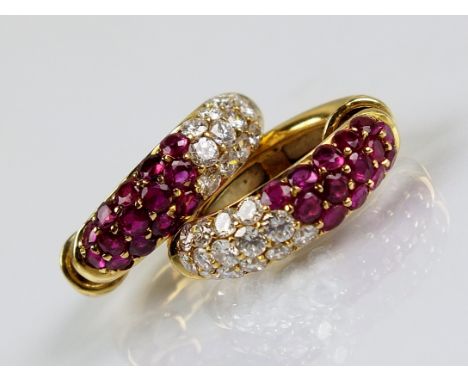 A pair of 18ct gold diamond and ruby hoop earrings, each designed as a three rows of fourteen round mixed cut rubies and four