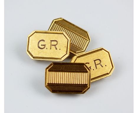 A pair of 9ct gold cufflinks, the canted rectangular plaques with engine turned decoration and engraved initials 'G.R.', hall