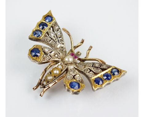 A late 19th/early 20th century diamond, ruby, sapphire and split pearl set butterfly brooch, the butterfly naturalistically m