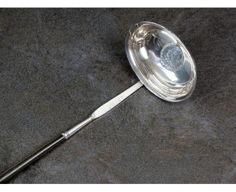 A white metal toddy ladle with turned whalebone handle, the bowl with engraved initials and coin inset, 36cm long, weight 1.4