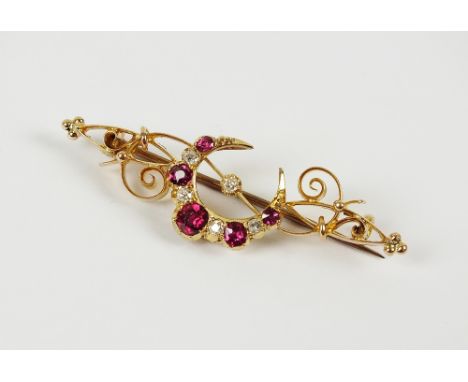 A ruby and diamond crescent bar brooch, designed as a graduated nine stone ruby and diamond crescent surrounding a further di