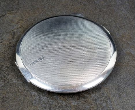 A silver mounted compact, Barker Brothers Silver Ltd, Birmingham 1932, of circular form with engine turned decoration, the hi