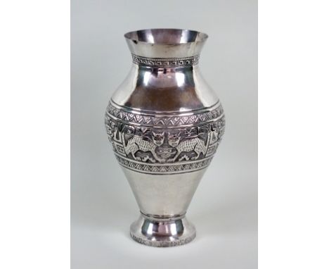 A South American white metal vase, of baluster form with embossed and chased stylised Mayan motifs, not stamped, 44cm high