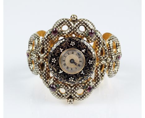 A 19th century continental yellow metal and enamel openwork hinged bangle with central fob watch, the white and black enamel 