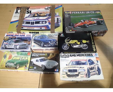 Selection of eight part built plastic car and motorcycle kits, various scales and types, contents unchecked, plus four empty 