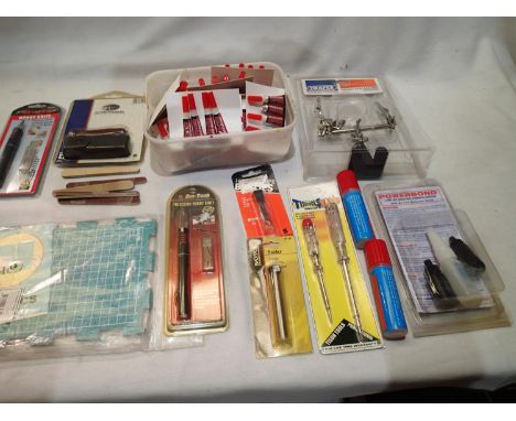 Selection of modelling tools including a cutting mat, Helping Hand, knife, solder, glue sticks, emery boards, plus a quantity