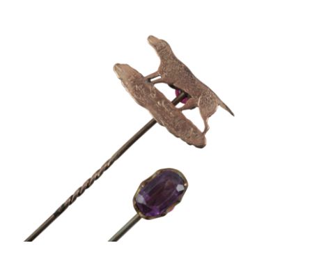 A GOLD-COLOURED METAL HOUND STICK PINtop tests as 14ct, 6.5cm long; together with an amethyst topped stick pin, 6.5cm long, c