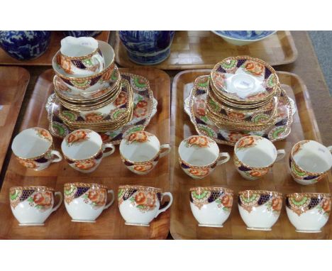 Two trays of English fine bone china part teaware in Imari colours, similar to the 'Heirloom' pattern: twelve teacups and sau