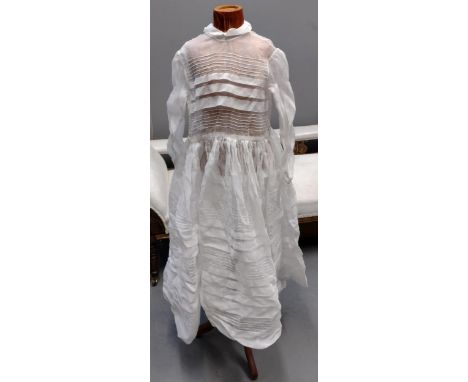 Two items of early 20th Century vintage children's clothing; one a sheer cotton long sleeved dress with stripes and a green a