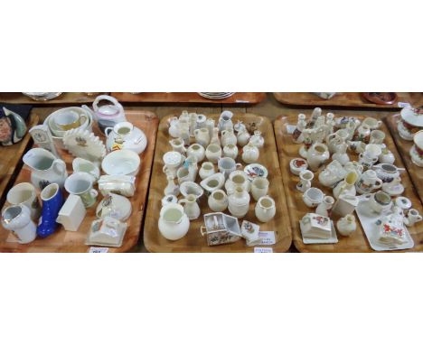 Three trays of crested ware souvenir items to include: pigs, urns, vases, top hat, miniature cheese dishes, figure of a gentl