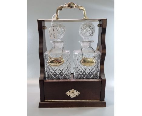 Reproduction mahogany finish and glass two section tantalus with Gin and Whisky silver plated decanter labels, silver plated 