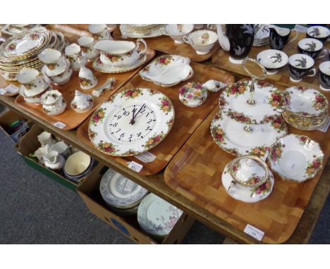 Five trays of Royal Albert 'Old Country Roses' china: two wall clocks, five milk jugs, two sugar bowls and a sucriere, gravy 
