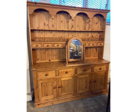 Modern natural pine rack back dresser with spice drawers and four cupboards to the base.  Together with a dressing table swin