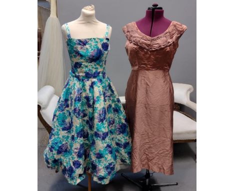 Two 50's/60's vintage evening dresses; one is a floral printed ball gown type dress with built in underskirt and a dusky pink