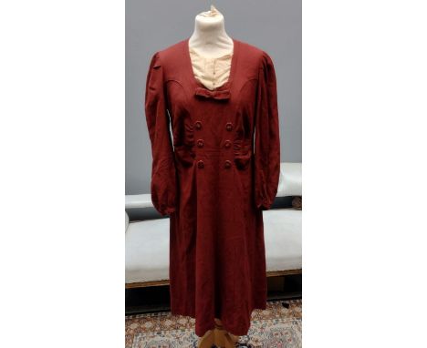 Two vintage 1940's burgundy colour day dresses; one with bow and button detail down the front, the other with tiered skirt an