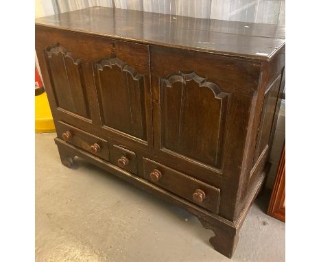 18th century Welsh oak coffer, now converted to a cupboard having three ogee fielded panels above three drawers on a projecti