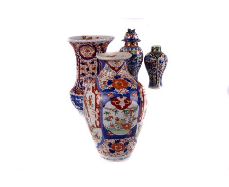 Two 19th century Imari vases,  of baluster and ovoid form respectively, together with three smaller covered vases and a trink