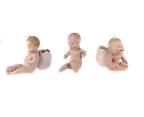 Three 19th century German bisque piano babies, two with cracked egg shell support 