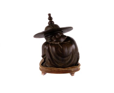 A 19th Century Chinese bronze figure of a sleeping immortal wrapped in his cloak,  wearing a decorated wide brimmed hat with 